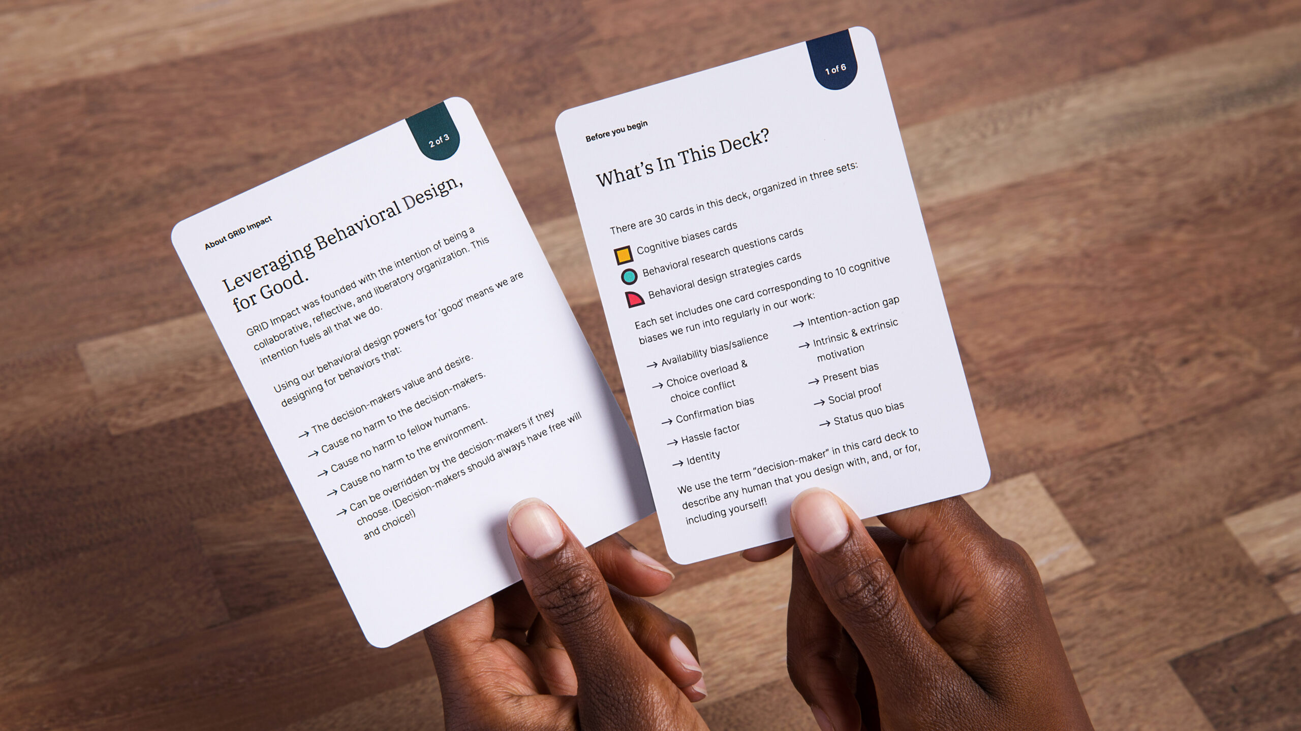 GRID-Impact-10 A photo of hands holding two cards from the Behavioral Design Cards carddeck
