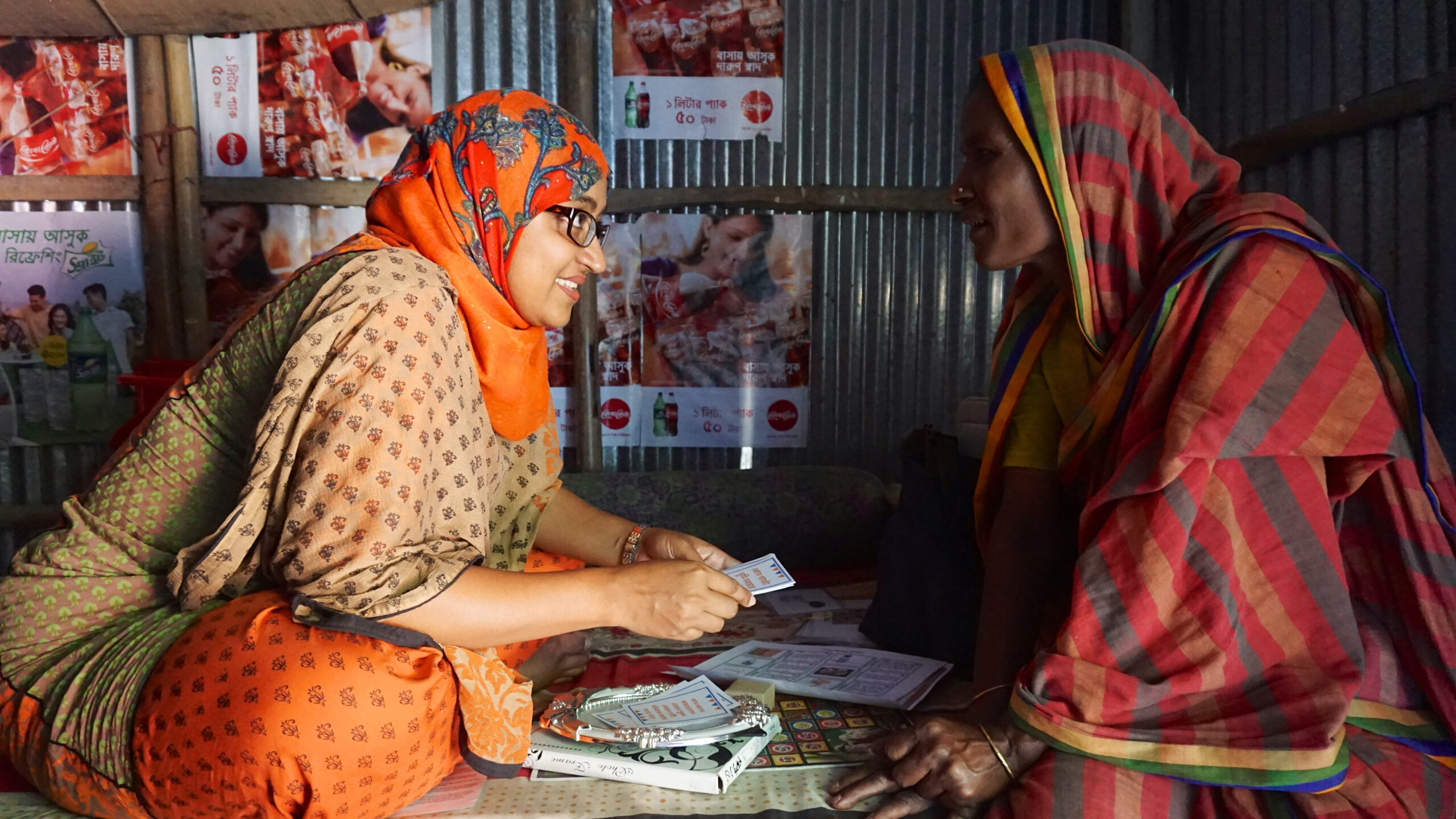 GRID-Impact-26 A photo of two woman sitting opposite of each other discussing a project